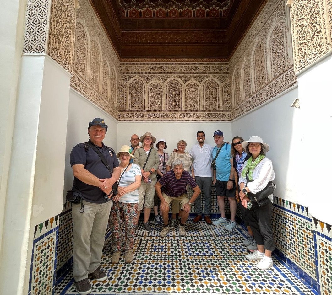 Gathered with travelers inside a traditional Moroccan architectural interior